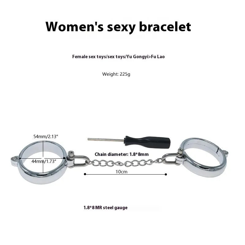 Silver zinc alloy metal handcuffs and footcuffs set for adult bondage play on a dark background.