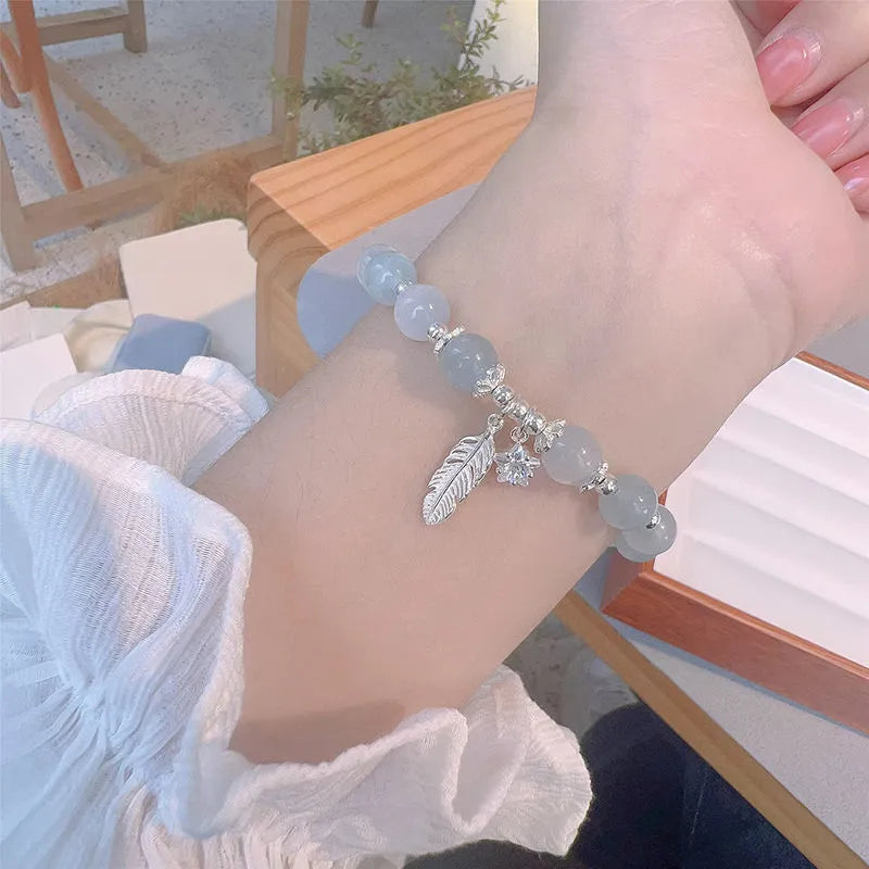 Korean style glass crystal bracelet with feather XingX blue moonlight colour and eight Awn star design