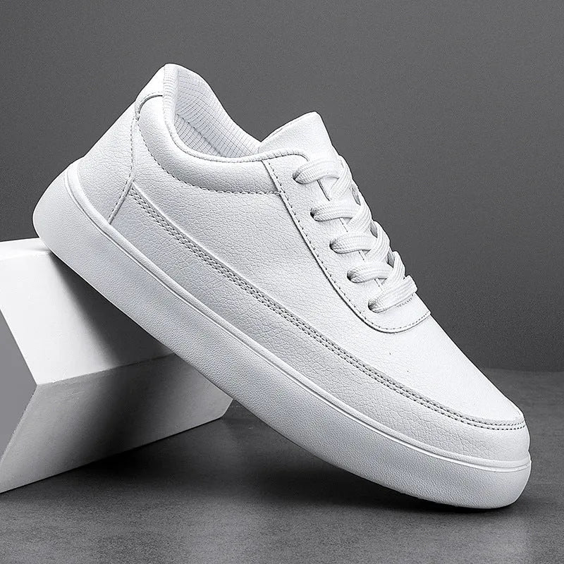 Women's white leather lace-up flat casual shoes on a solid background.
