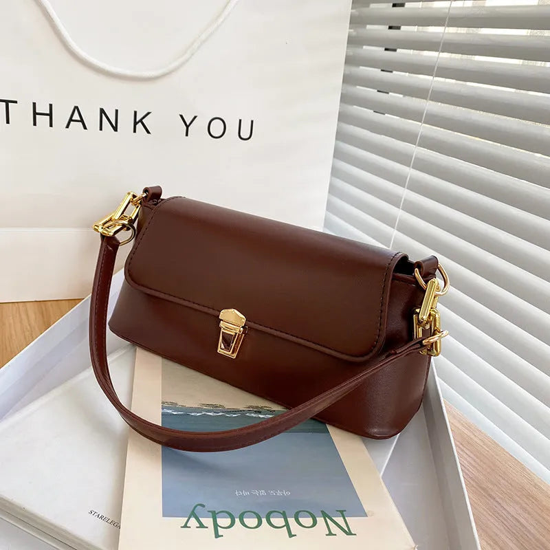 Brown French casual underarm bag with single shoulder chain strap and sandwich pocket design