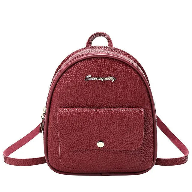 Black PU women's small backpack convertible to a shoulder bag, shown with a mobile phone for scale.