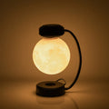 3D LED moon night light with magnetic levitation, floating ball, iron base, black finish on a desk