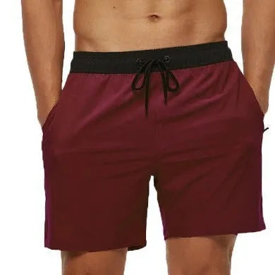 Men's blue running shorts with a stitching waistband, drawstring, and zipper pocket.