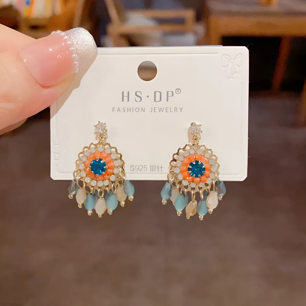Round crystal tassel earrings with diamond embedded design in thick gold plated copper