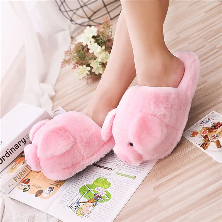 Pink pig-themed plush floor slippers for adults on a white background