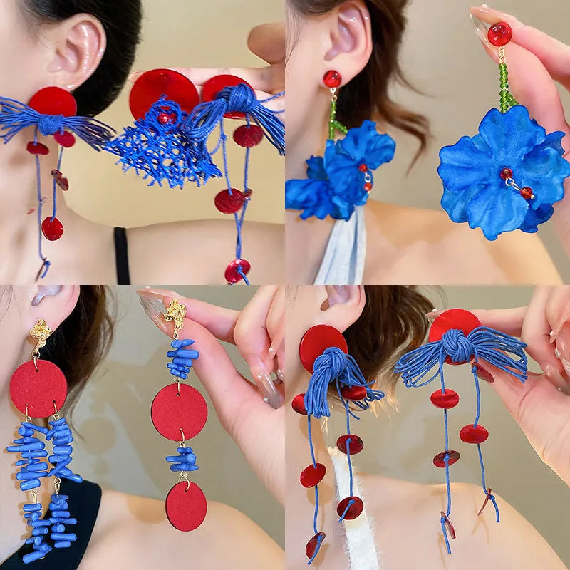 Geometric-shaped cloth earrings in silver needle and blue resin flower colours.