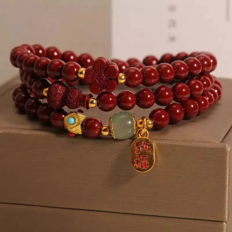 Red cinnabar bracelet with 6mm beads showing multi-circle gourd and five petal flower geometric design