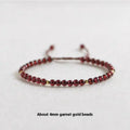 Hand-woven garnet red rope bracelet with flexible wire on a neutral background.