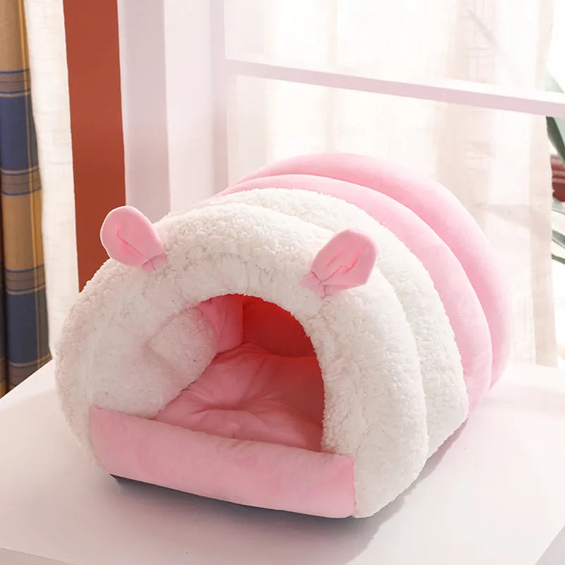 Closed cat nest bed in blue colour with removable cushion shown in home setting