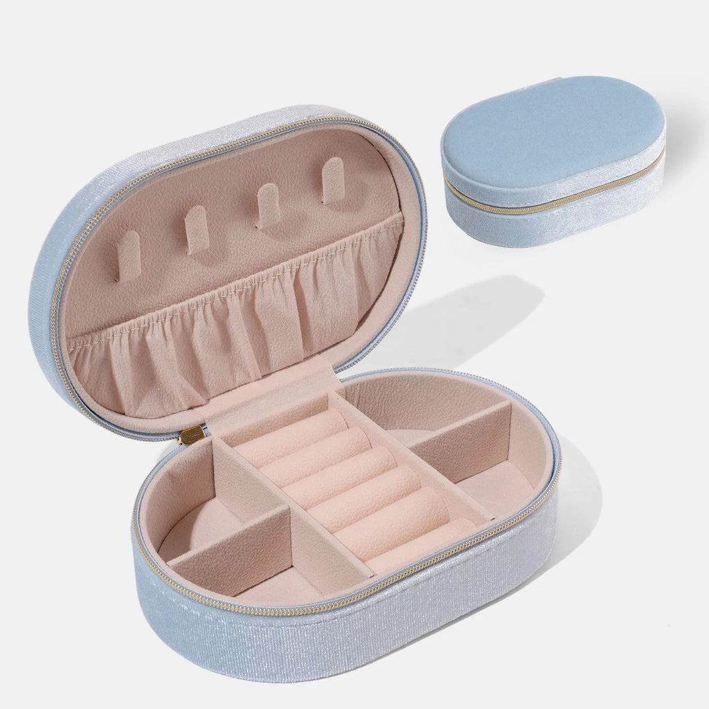 Oval velvet jewellery storage box in lake blue with flannel interior and removable hook.