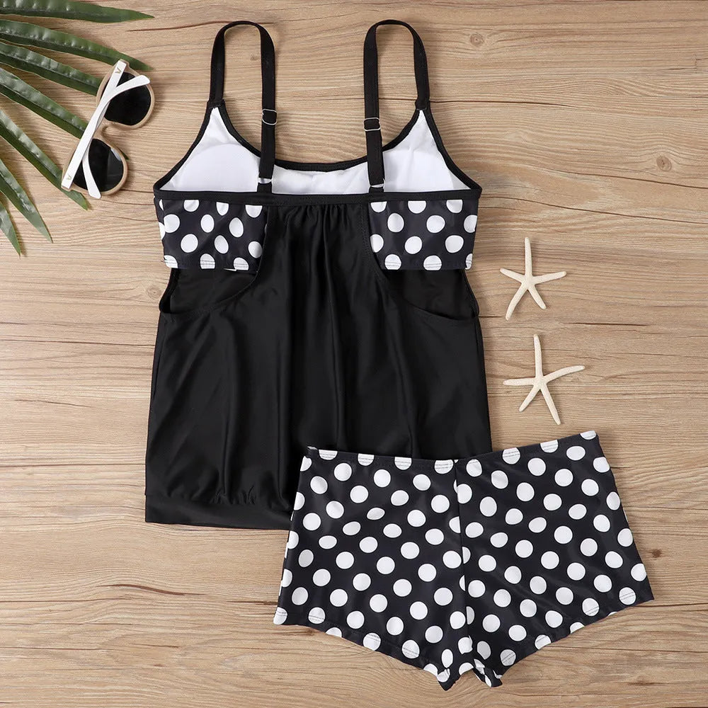Women's black polka dot high-waisted boxer swimsuit set shown on a model.