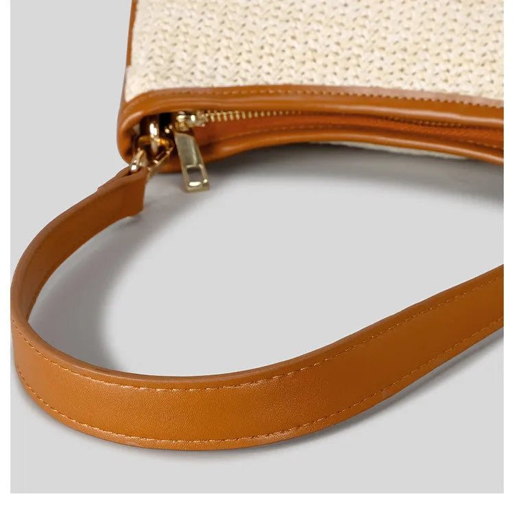 Khaki hand-woven straw crossbody bag with a single strap and contrasting detail.