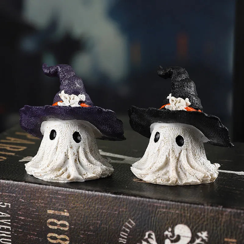 Close-up of a detailed black and a purple resin wizard hat ornament for holiday decoration.