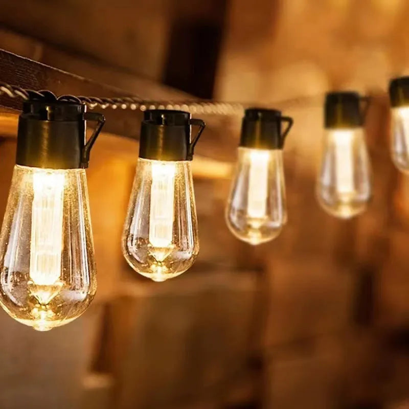 Retro glass infusion bottle shaped outdoor string lights on a patio