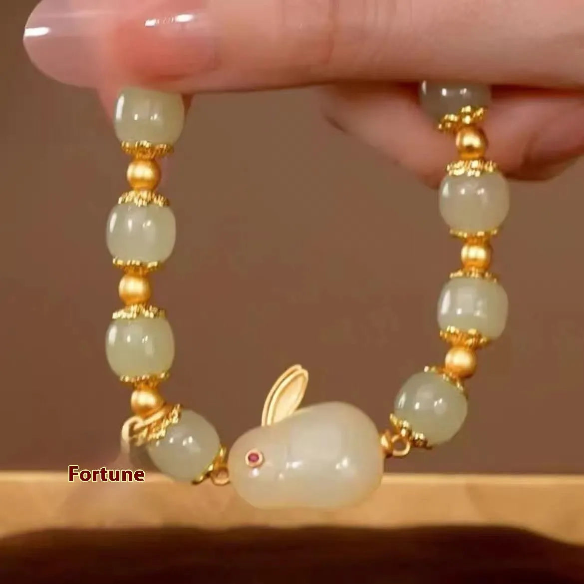 Green lucky jade hare bracelet for women with Chinese zodiac animal design and electroplated finish.