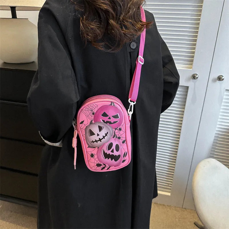 Halloween graffiti print mini crossbody bag with cartoon pumpkin ghost bat design in multiple colours.