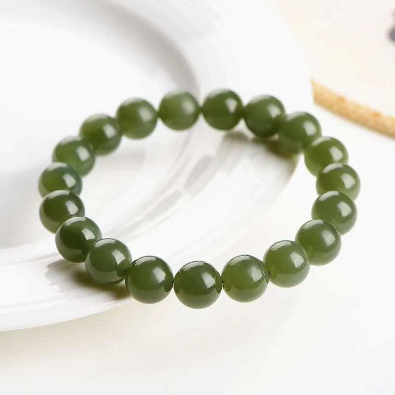 A polished Hetian jade ball bracelet showing beads in a clear ice-like colour on a wrist.