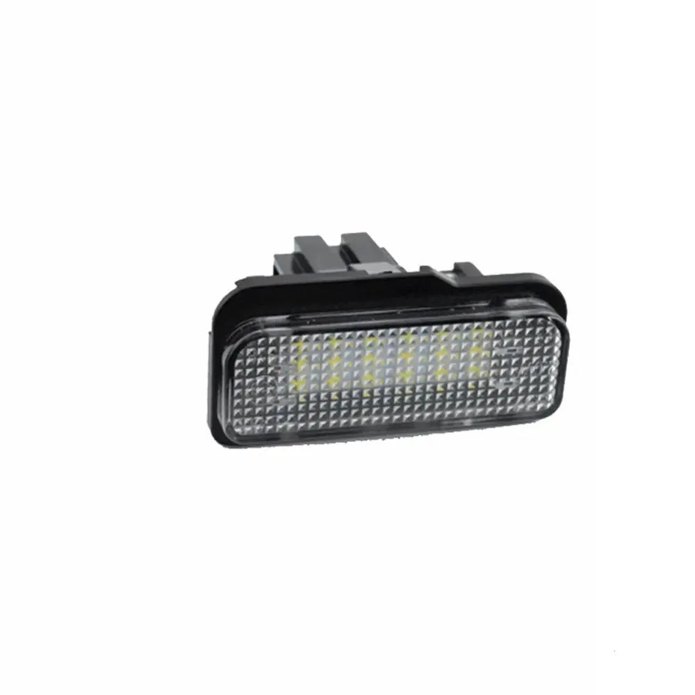 Mercedes Benz LED licence plate light unit with 18 white LEDs, shown next to a ruler for scale.