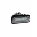 Mercedes Benz LED licence plate light unit with 18 white LEDs, shown next to a ruler for scale.