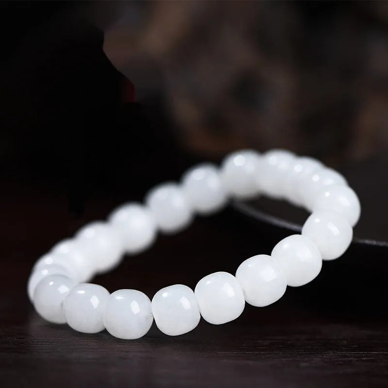 White Hetian jade barrel beads bracelet laid flat, showing bead sizes 5x6mm, 7x8mm, and 8x10mm.