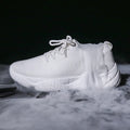 Women's white thick-soled flying woven trainers with pink perforations and a front strap on a rubber sole.