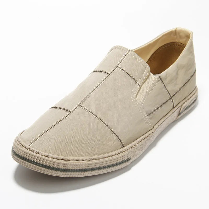 Men's low-top slip-on canvas shoes in various colours showing round toe and vulcanised rubber sole.