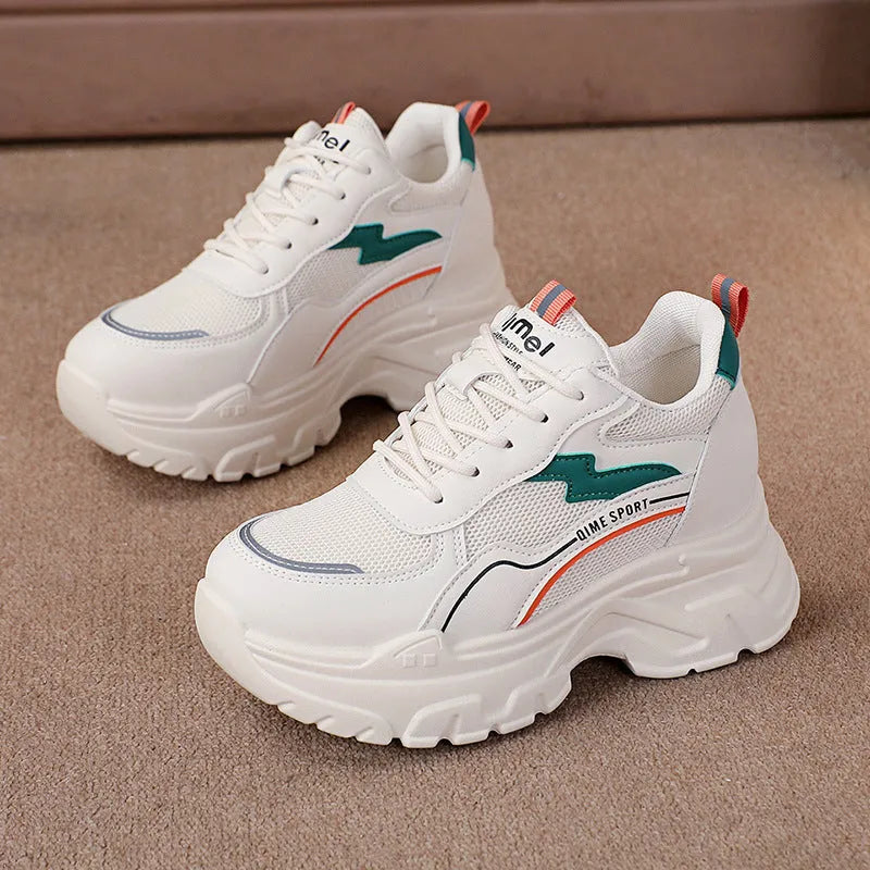 Women's white low-top sports trainers with cross shoulder straps and front laces, made of breathable mesh.