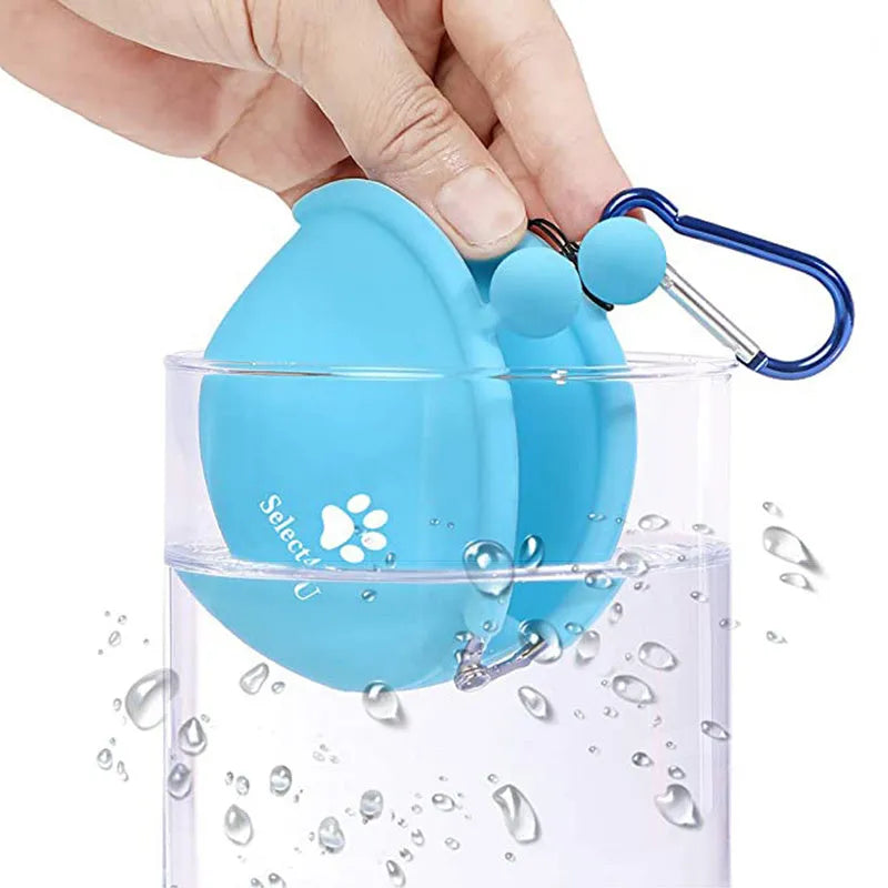 Yellow silicone dog training treat pouch with hook and loop closure, shown on a waist belt