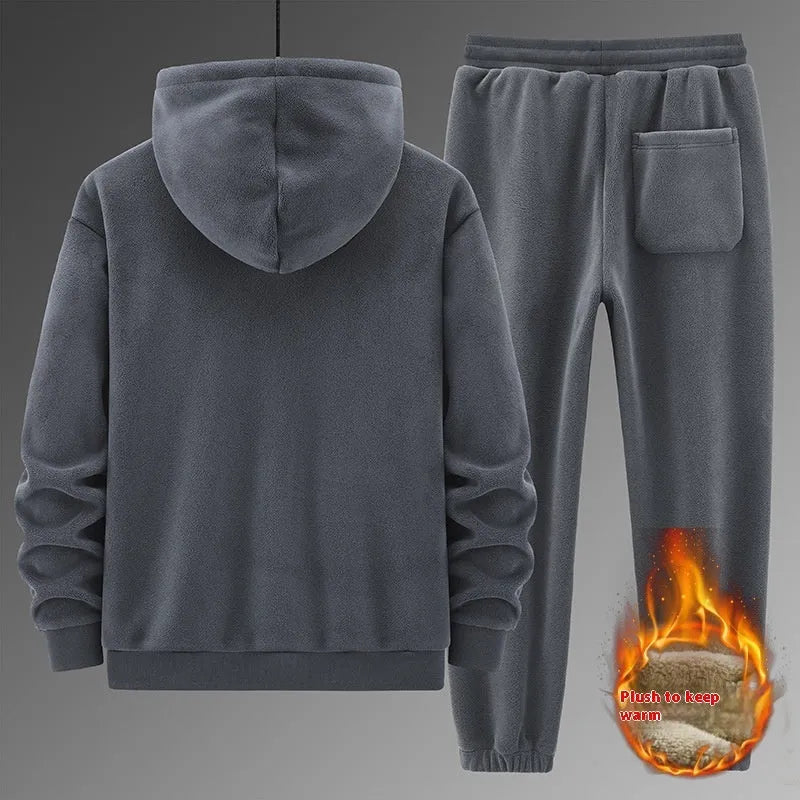 Man wearing a grey cashmere hooded sweater and matching cotton pants from a casual sports suit set.