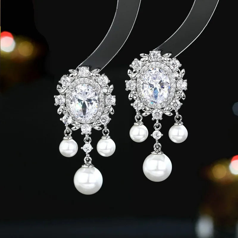 Oval geometric copper earrings with inlaid zircon crystals and pearl tassels in light purple colour