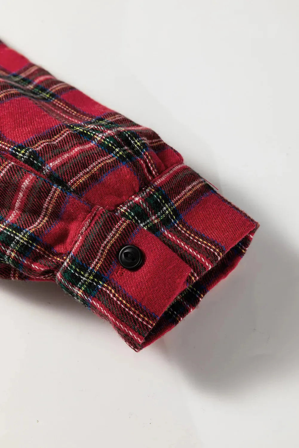 Red plaid mini dress with shirt collar, button front, long sleeves, and ruffle hem detail