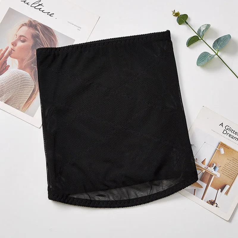Thin black mesh belly band for waist trimming and postpartum tummy support laid flat.