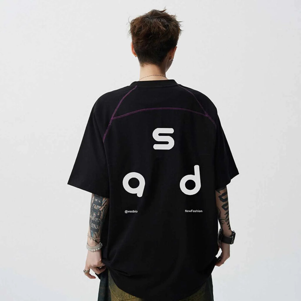 A loose-fit black cotton T-shirt with a white letter print on the front, showing a round neck and short sleeves.
