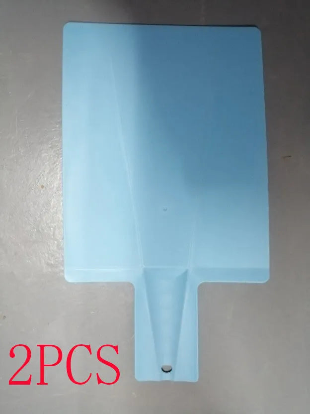 Green folding plastic cutting board with non-slip texture and hanging hole on kitchen countertop