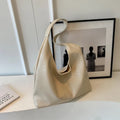 Women's casual shoulder bag in soft PU leather with sandwich pocket and visible sewing thread detail