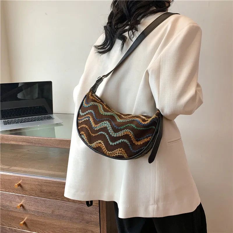 Women's woven straw crossbody bag showing internal phone and document pockets in corrugated brown colour
