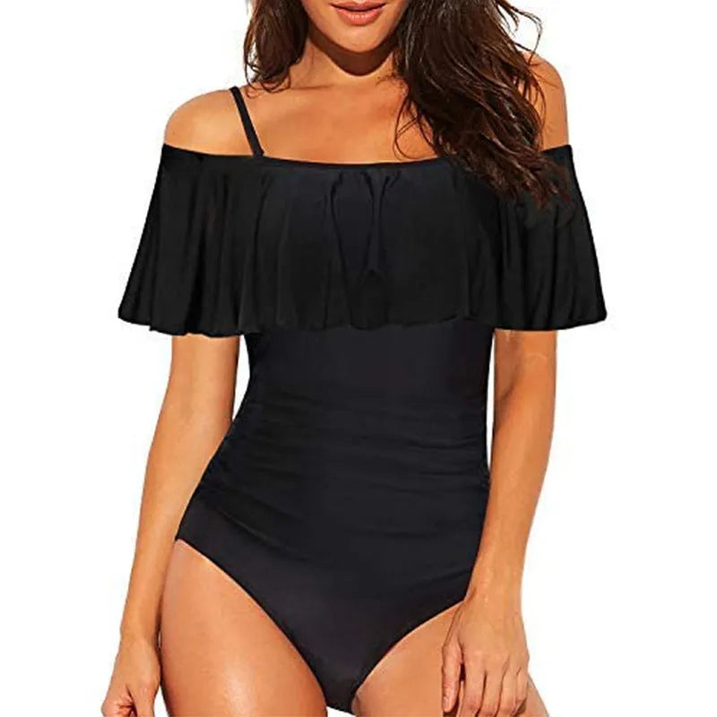 Black one-piece cut-out swimsuit with ruffled straps and tube top style.