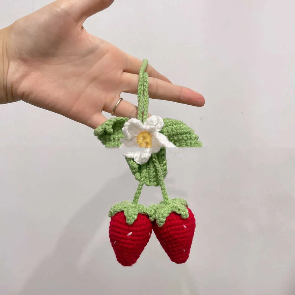 Handmade crochet strawberry-shaped car pendant made from cotton and hemp yarn.
