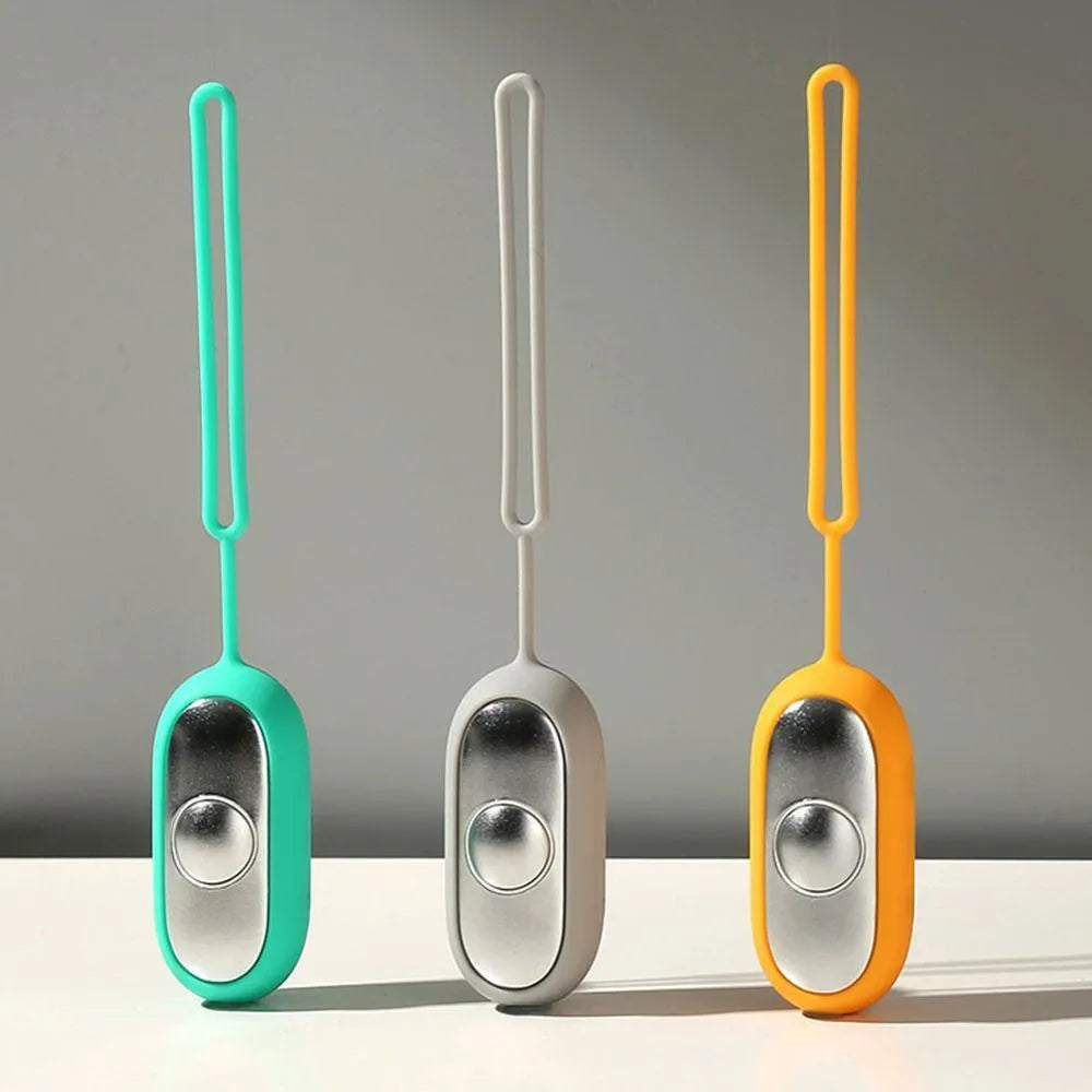 Handheld microcurrent sleep aid device with round control button in grey, green, or orange colours