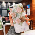 Dream Shell soft TPU iPhone case with rose flower design in brown, shown on an iPhone.