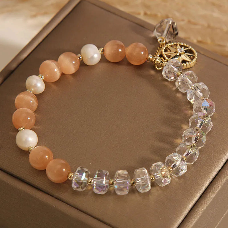 Gold-plated women's bracelet with an eight Awn star design and an orange crystal inlay.