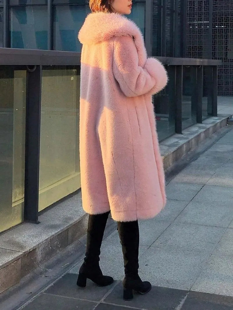 Grey women's mid-length faux fur coat with a leather panel and fur collar on a hanger.