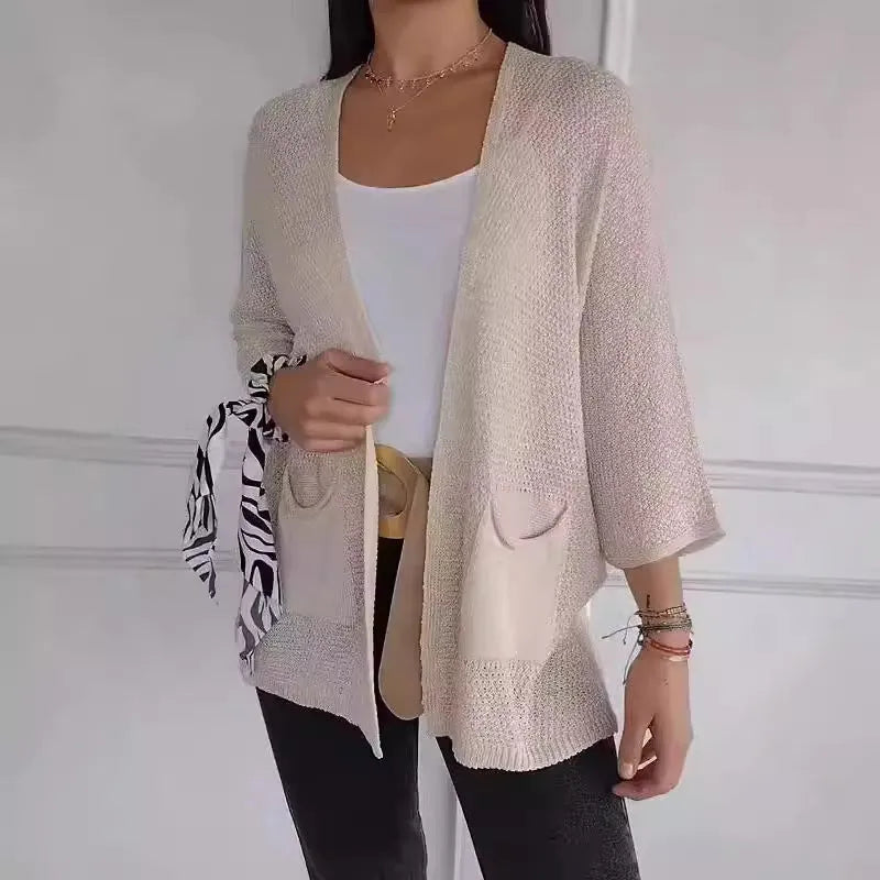 Women's army green waffle knit cardigan coat with nine-quarter length sleeves and pockets.