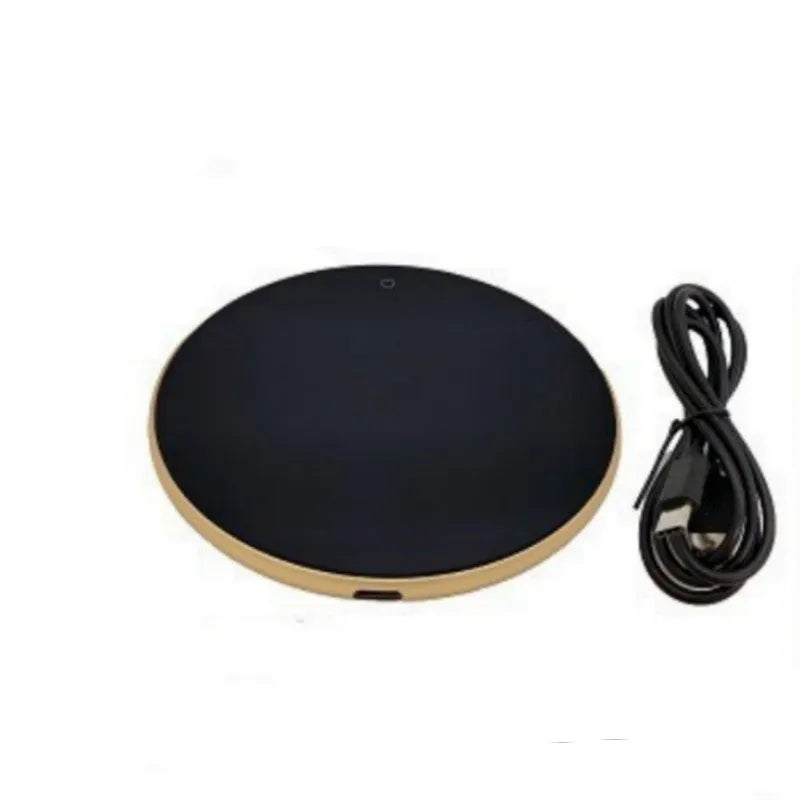 Black USB-powered beverage warming coaster with tempered glass top on a wooden desk