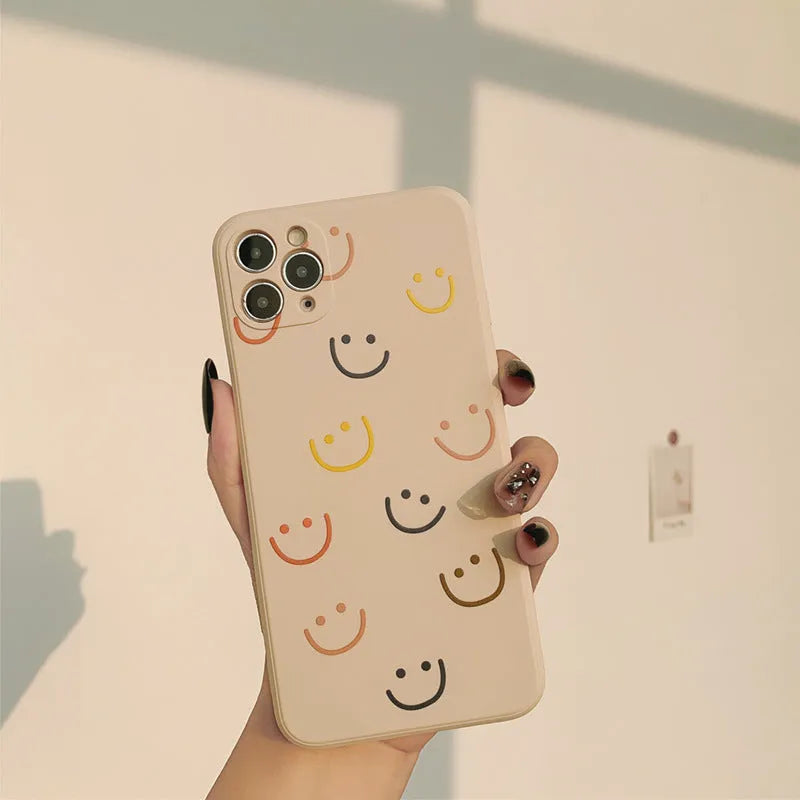 Simple TPU iPhone case with painted smiley face design in three colour options