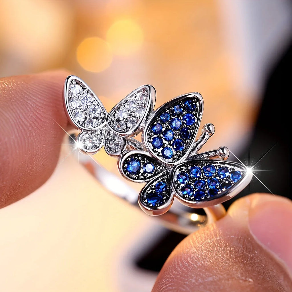 Blue and white butterfly design ring for women on a copper band, showing side detail.