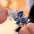 Blue and white butterfly design ring for women on a copper band, showing side detail.
