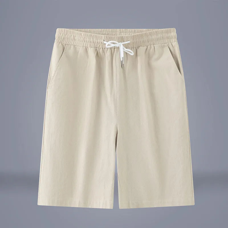 Solid colour cropped cotton linen trousers with a drawstring waist, shown in army green.