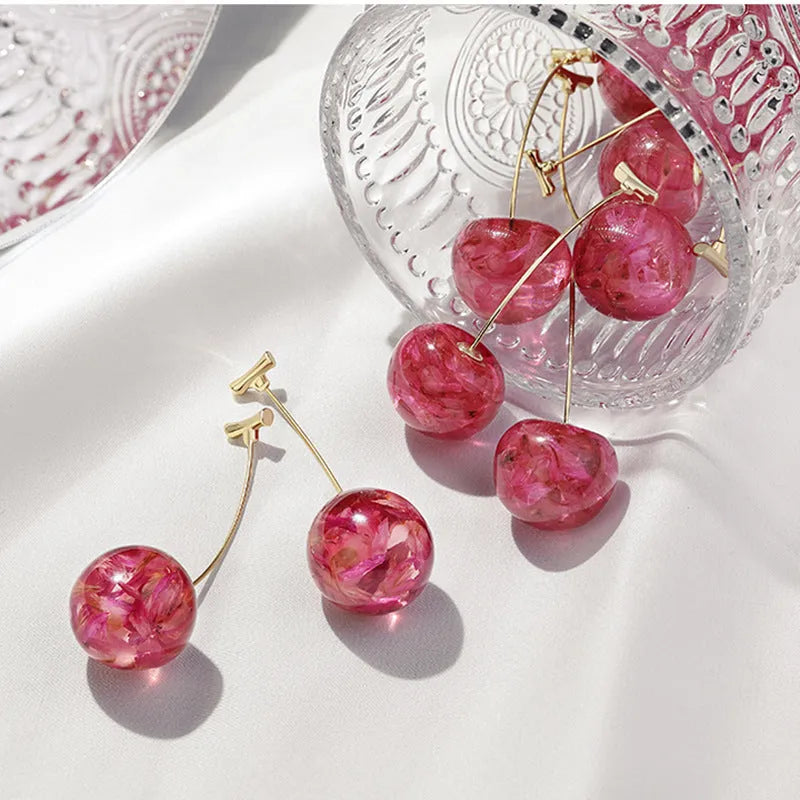 Long red French dried cherry earrings for women in plated alloy design on white background
