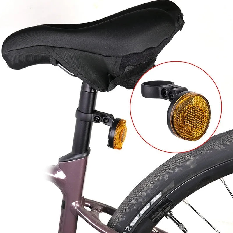 Red plastic anti-theft bicycle taillight bracket mounted on seat post with reflective surface